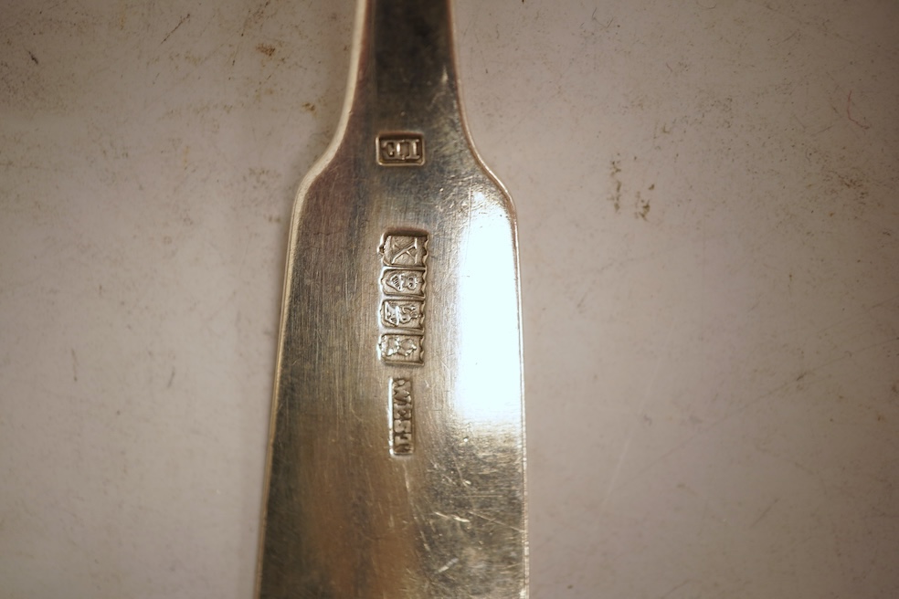 A George III silver fiddle pattern stilton scoop, John Lias, London, 1816, 20cm, together with two Georgian silver sauce ladles, a similar sifter ladle and a William IV shell pattern fish knife, 8.9oz.
